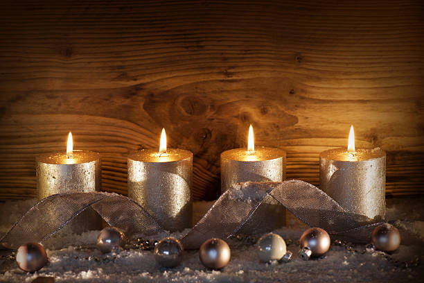 Silver candles for the 4. Advent Still life with silver candles for the 4. advent in front of a wooden wall funkeln stock pictures, royalty-free photos & images