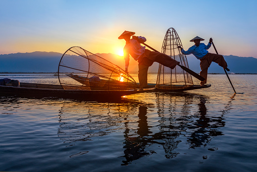 Fishermen sihouettes at Inle lake on sunset, Myanmar