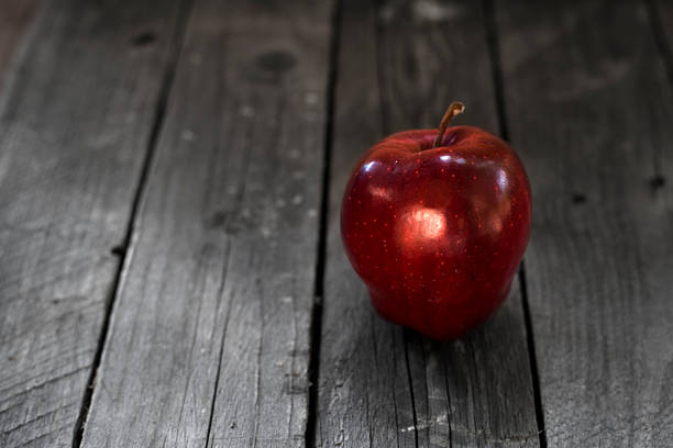 istock Apples on wooden background 614517068