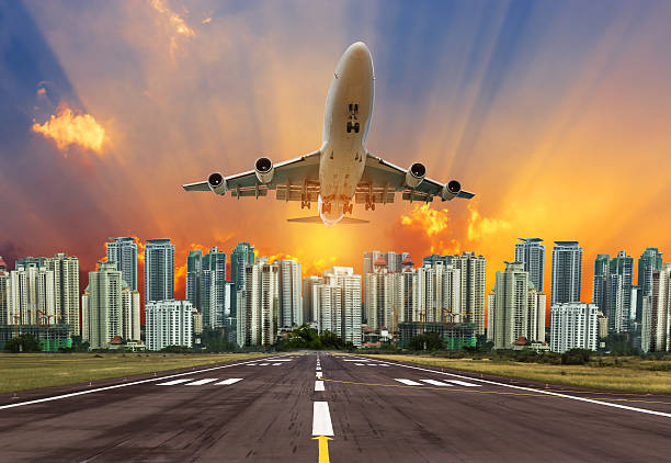 istock Silhouette airplane flying take off from runway on sunset 614519010