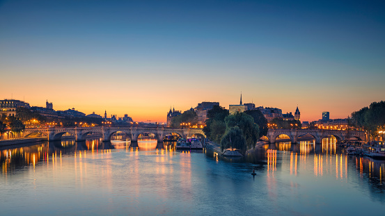 Panoramic image of Paris riverside during sunrise.
