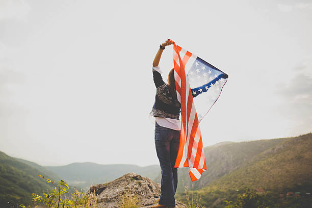 istock Young woman holding a flag 614521928