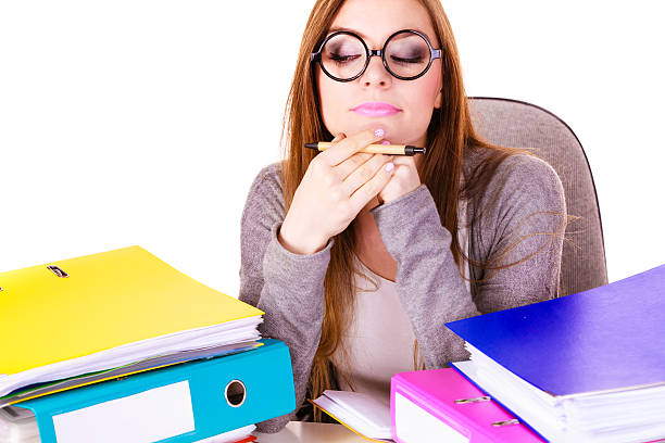 istock Woman sitting at desk in office and thinking 614523392