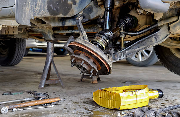 istock Car mechanic  check and maintenance suspension car. 614523606
