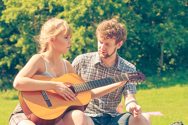 istock Young couple camping playing guitar outdoor 614523796