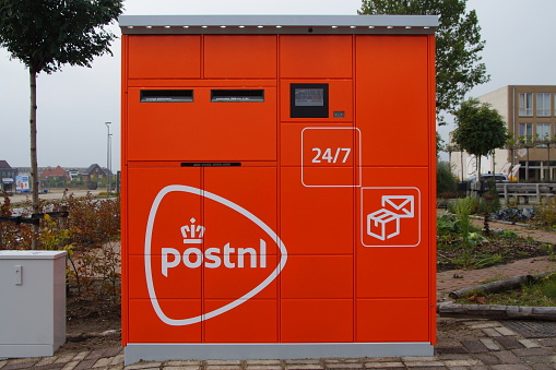 Almere Poort, The Netherlands - Oktober 15 2016: PostNL parcel and letter machine by the side of a public road in the city of Almere.