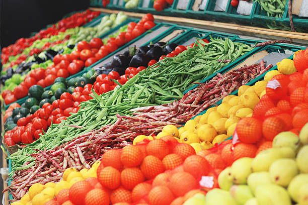 all vegetables in one shot mixing of vegetables in the grocery with mirror reflection. lemon,bean,eggplant and the other vegatables are included in the bench. That will be bought and eaten by customer. produce section stock pictures, royalty-free photos & images