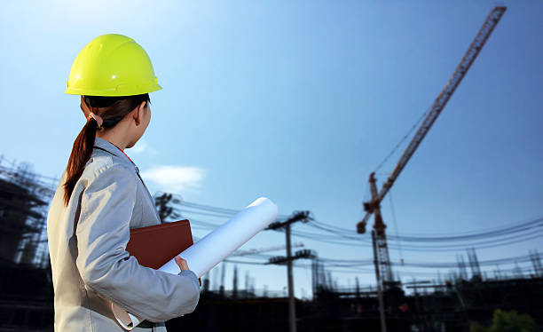 istock portrait women asia engineer working and holding blueprints 614527852
