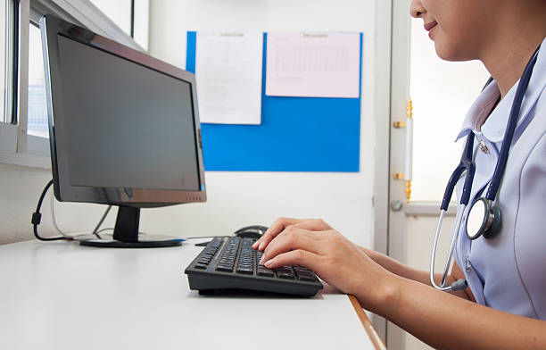 istock Doctor working with computer at desk in the hospital 614527890