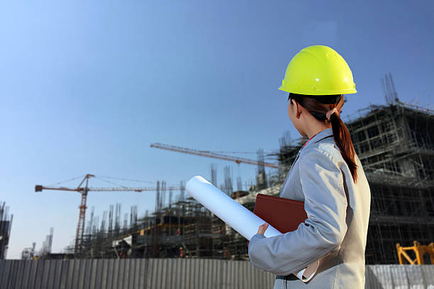 istock portrait women asia engineer working and holding blueprints 614527988