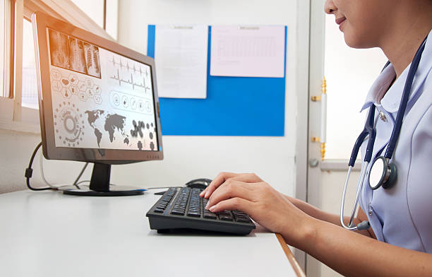 istock Doctor working with computer at desk in the hospital 614528002