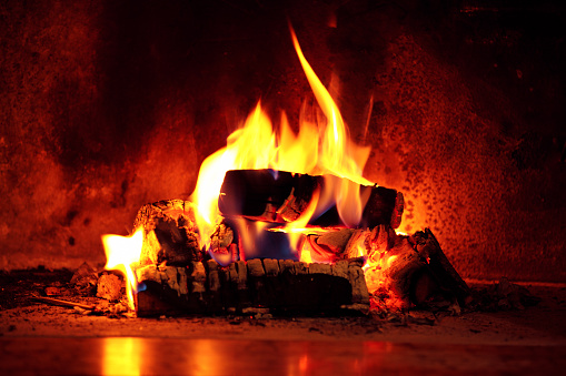 Close up shot of burning firewood in the fireplace.