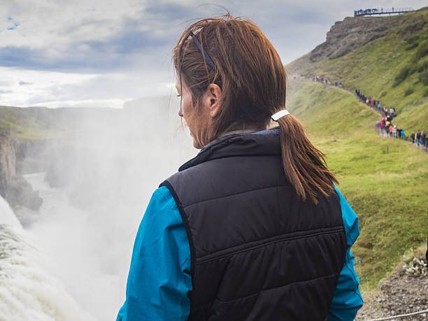 istock Woman is standing at a Gullfoss waterfall - Iceland 614529720