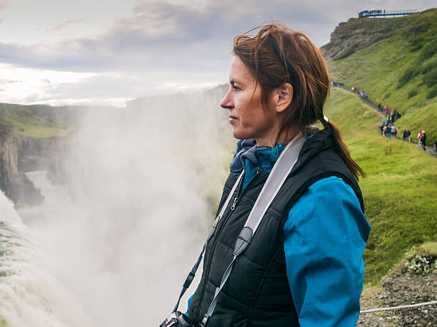 istock Woman is standing at a Gullfoss waterfall - Iceland 614529776
