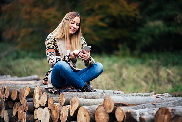 istock girl using phone in the nature 614530162