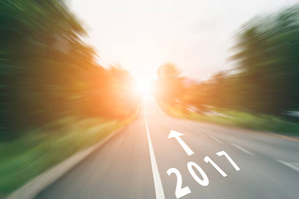 istock arrow line and 2017 on speed road with sunlight 614530752