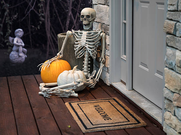 istock Skeleton and pumpkins in doorway for Halloween 614531096