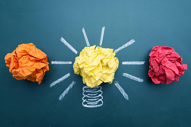 istock Paper Ball on Blackboard and Lightbulb Shape 614531524