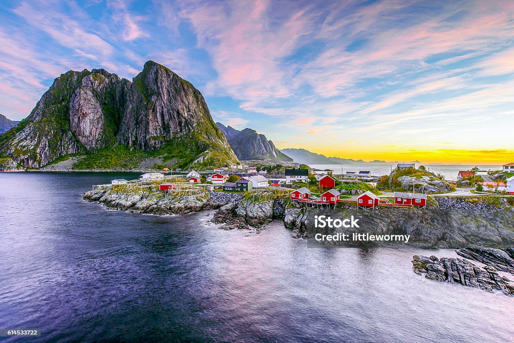 Lofoten, Norway in the morning Popular view of Fishing hut (rorbuer) in Hamnoy, Norway with Lilandstinden mountain peak as the background during sunrise Norway Stock Photo