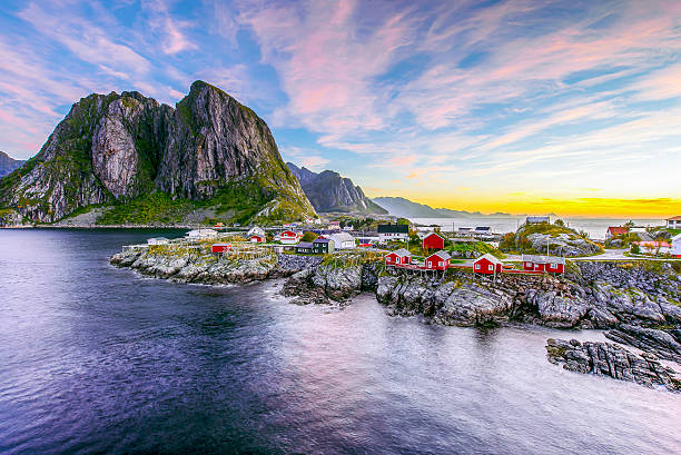 Lofoten, Norway in the morning Popular view of Fishing hut (rorbuer) in Hamnoy, Norway with Lilandstinden mountain peak as the background during sunrise lofoten stock pictures, royalty-free photos & images