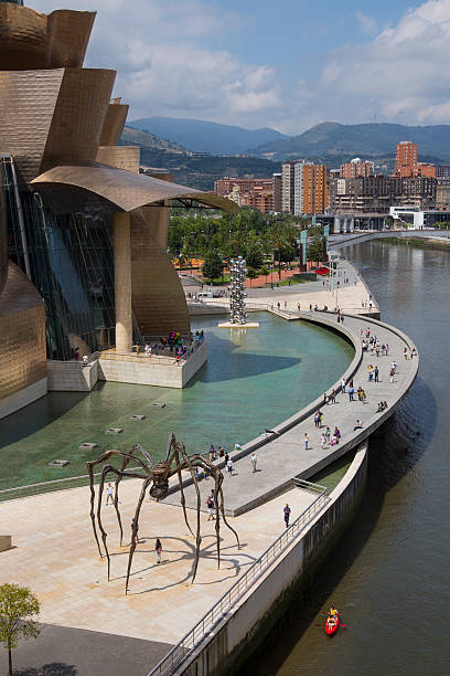 Bilbao, Spain - July 19, 2012: The seaport of Bilbao in the province of Biscay in northern Spain. View of the  Guggenheim Museum of modern and contemporary art, designed by Canadian-American architect Frank Gehry. Built alongside the Nervion River, which runs through the city of Bilbao, it is one of several museums belonging to the Solomon R. Guggenheim Foundation and features permanent and visiting exhibits of works by Spanish and international artists.