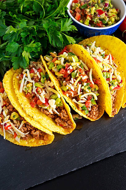 istock Mexican food - delicious taco shells with ground beef and 614534618