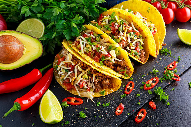 istock Mexican food - delicious taco shells with ground beef and 614534746