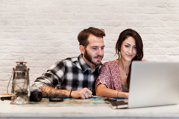 istock Young couple in love planning a trip 614535142