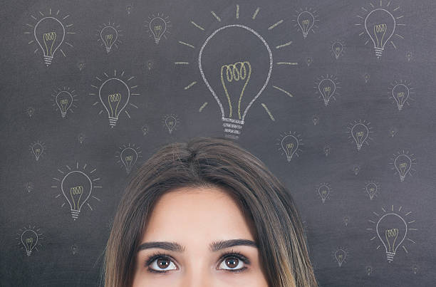 istock Beautiful Woman Thinking on Blackboard 614536450