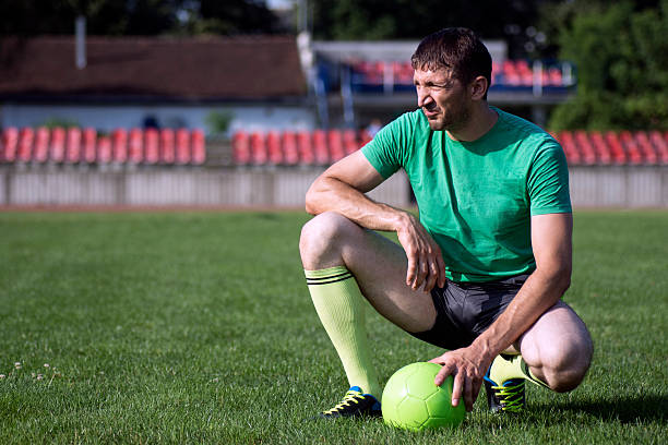 istock football player with ball 614537424