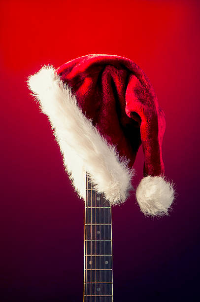 Red Christmas hat on guitar stock photo