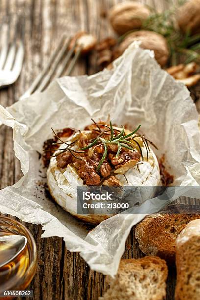 Baked Camembert With Walnuts Honey And Rosemary On Wooden Table Stock Photo - Download Image Now