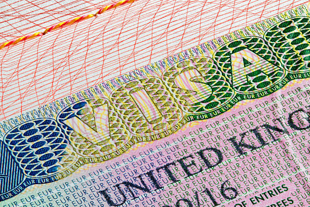 United Kingdom visa stamp in passport United Kingdom visa stamp on passport page schengen agreement photos stock pictures, royalty-free photos & images
