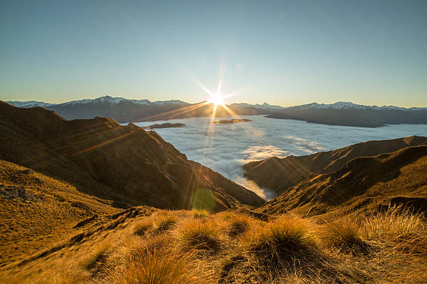 istock Last sun over the clouds from mountain peak 614609302