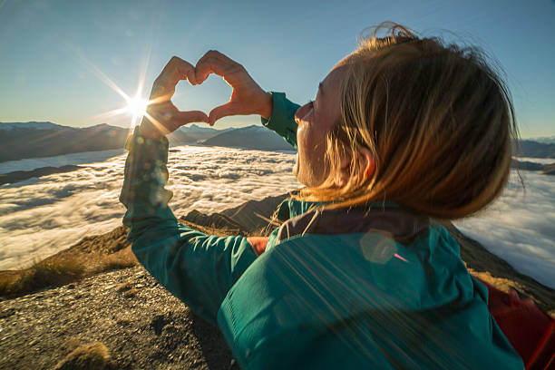 istock Woman loving view from mountain summit 614609498