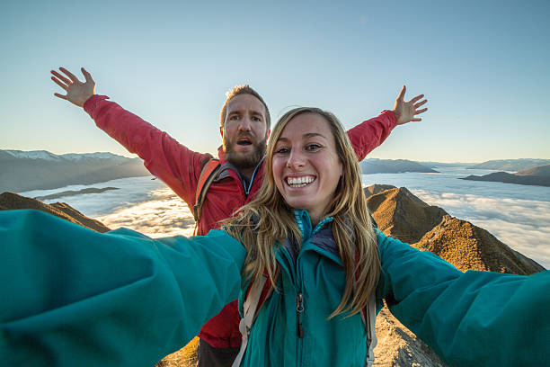 istock Young couple take selfie on mountain summit 614609678