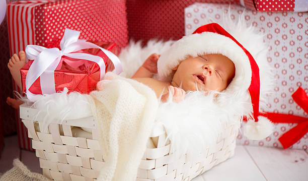 istock sleeper newborn baby in  Christmas Santa cap 614610490