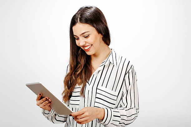 istock Beautiful young woman with digital tablet 614611168