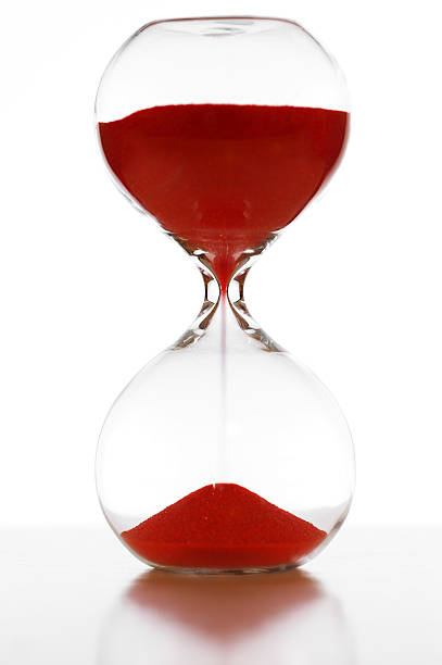 istock Glass hourglass with red sand 614613978