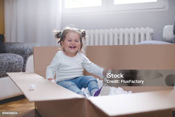 Baby Girl Playing In Box With Styrofoam Pellets Stock Photo - Download Image Now - Baby - Human Age, Box - Container, Family