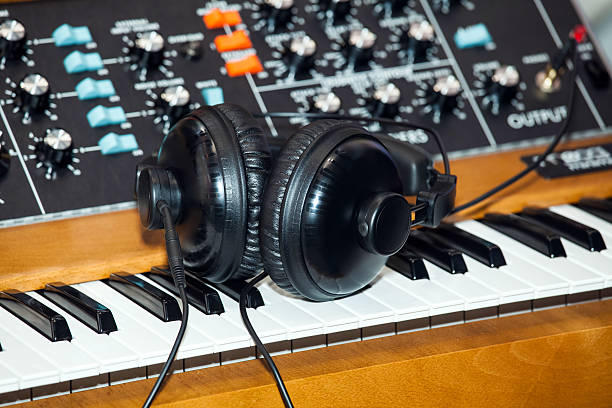 istock Black headphones on the keyboard piano 614617050