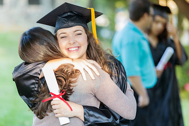 istock Happy college grad hugs her mom 614617594