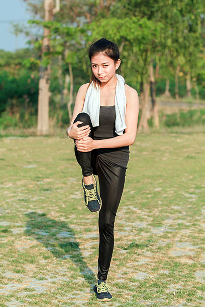 istock soft focus of Athletic woman asia warming up 614617962