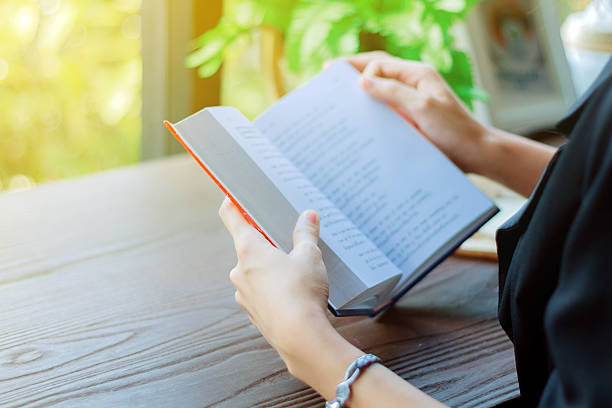 istock Asian woman reading a book  for relaxation . 614618444