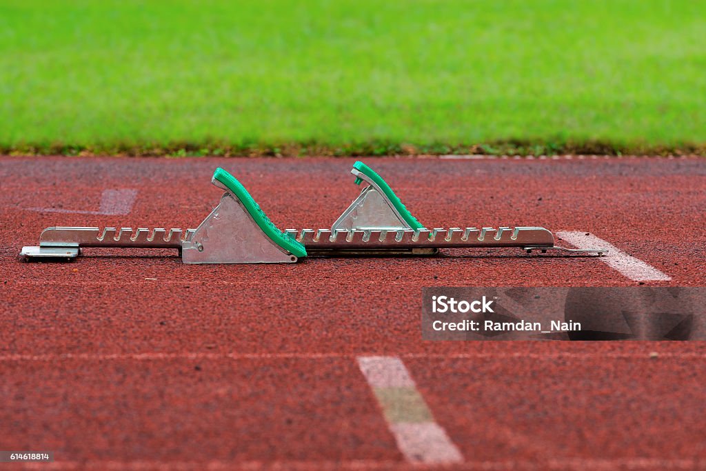 Athletics Starting Blocks on a red running track Achievement Stock Photo