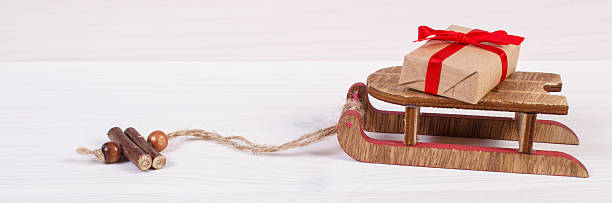 istock Wooden sled and wrapped gift for Christmas or other celebration 614622642