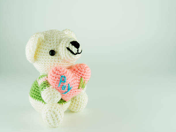 istock Teddy bear made from yarn,  hold heart. 614622700