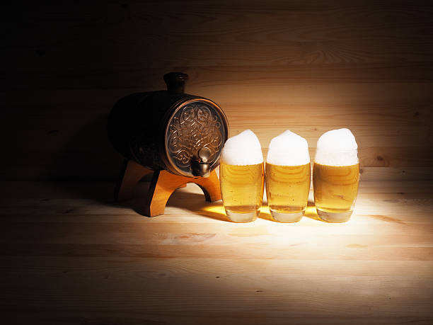 Barrel and glass of light beer on a wooden background