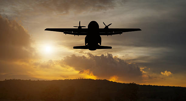 istock Airplane silhouette flying in the sky on sunset , 614625888