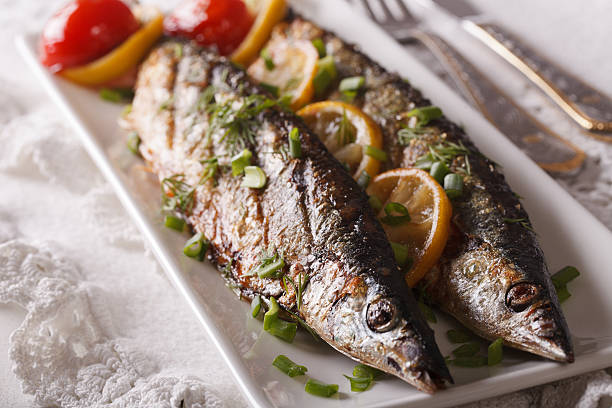 istock Fish saury grilled with lemon and chives 614625942